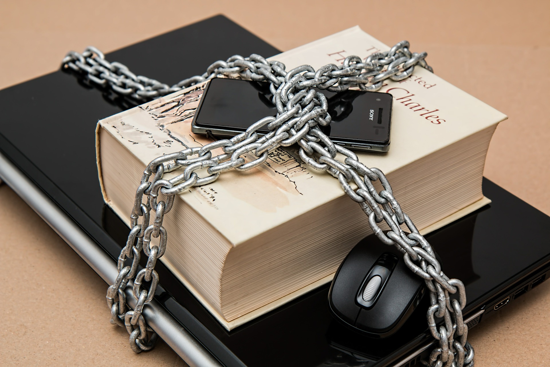 Mobile phone, book, and tablet chained together for mobile security