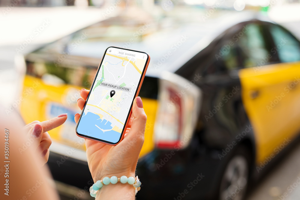 Person using taxi app on mobile phone and ride sharing safety