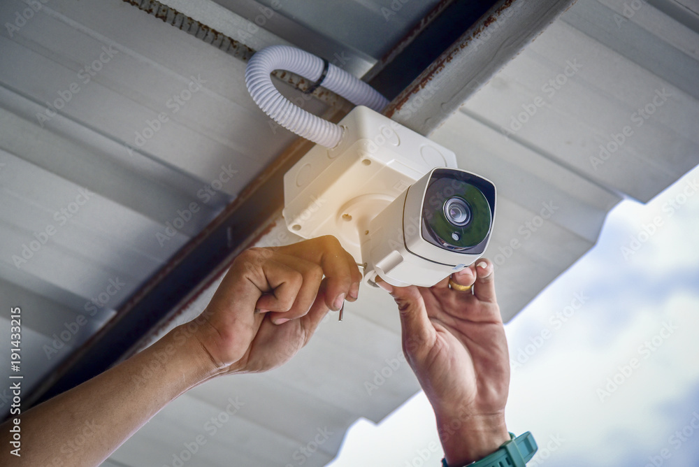 Technician installing CCTV camera system for security area. IP security cameras