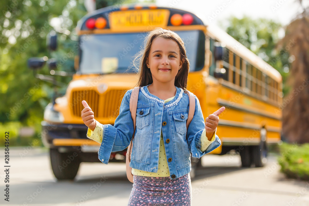 Little Girl Getting off the school bus. School bus safety