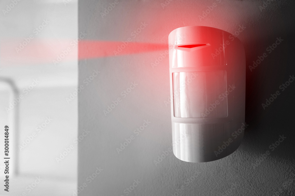 Modern motion sensor on wall indoors. Rochester NY Motion Detectors Installation
