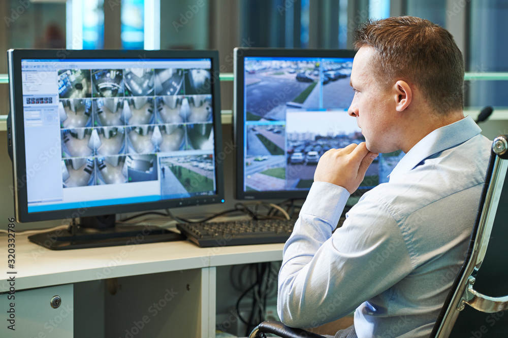 Security worker during monitoring. Video surveillance for business system.