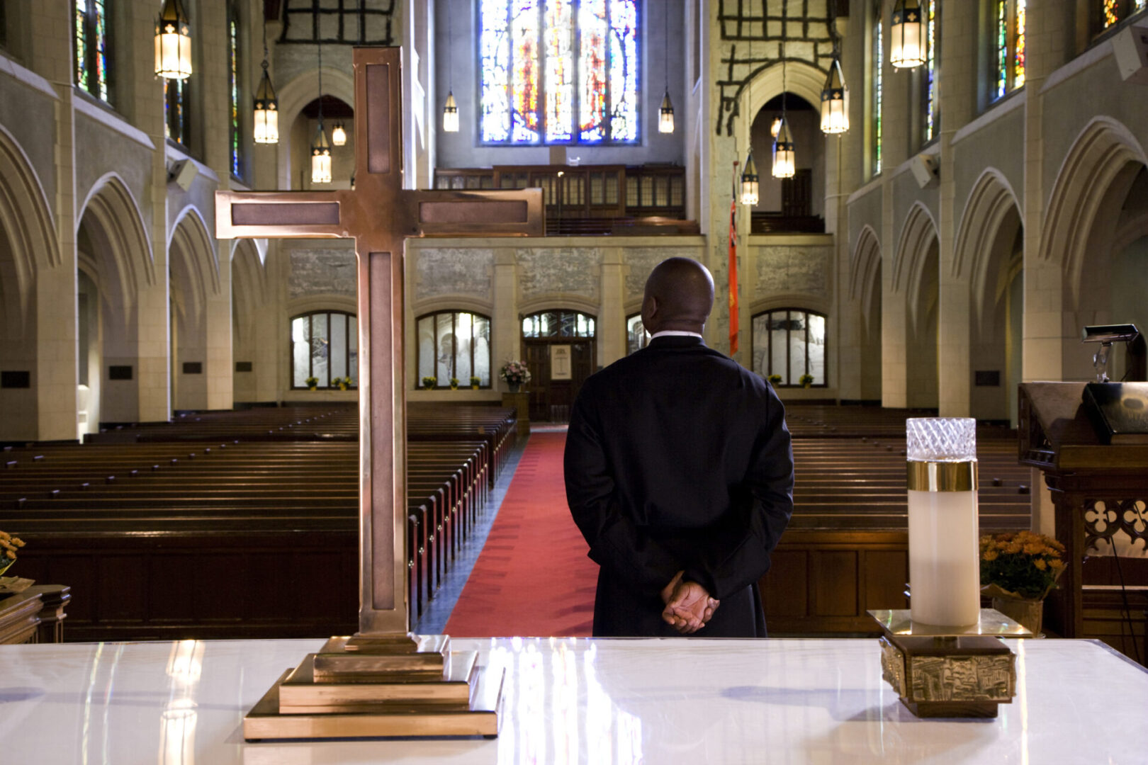 Person facing altar in empty church