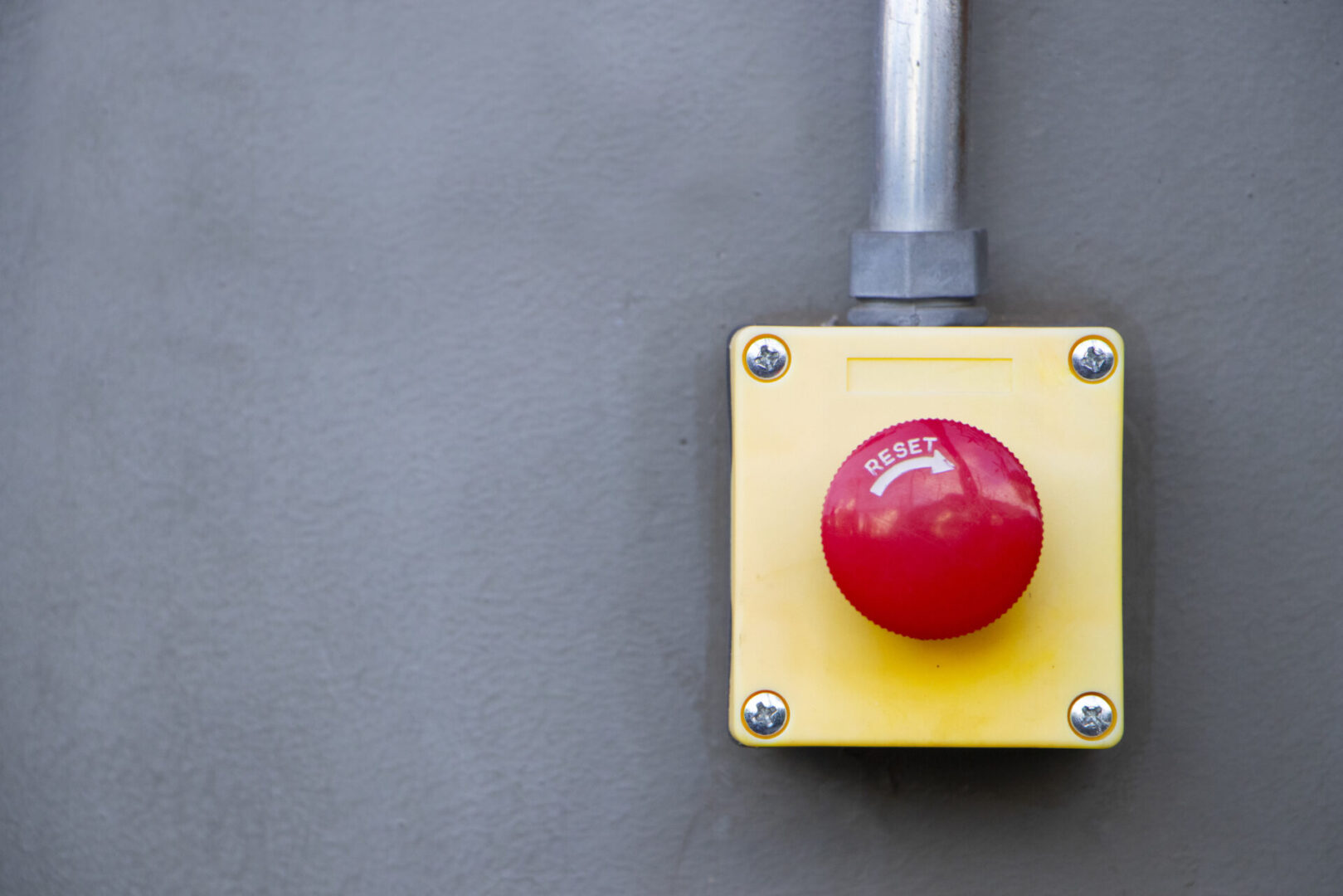 Emergency reset button on industrial wall
