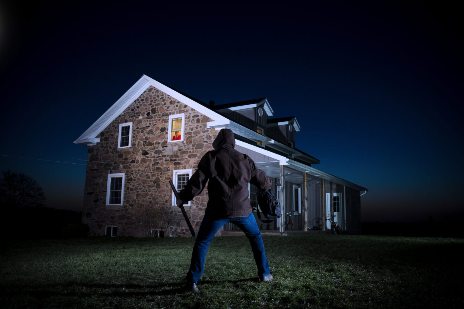 Suspenseful scene outside a stone house