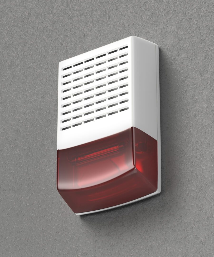 White fire alarm on gray wall