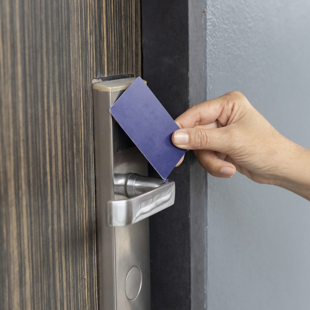 Hand using card key on hotel door