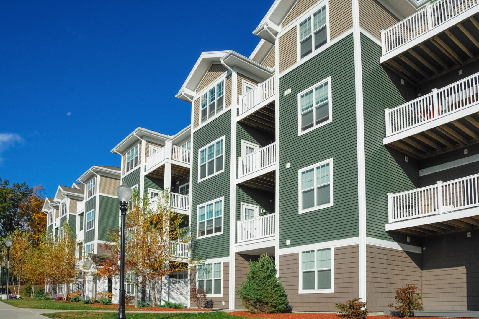 Green residential complex under blue sky