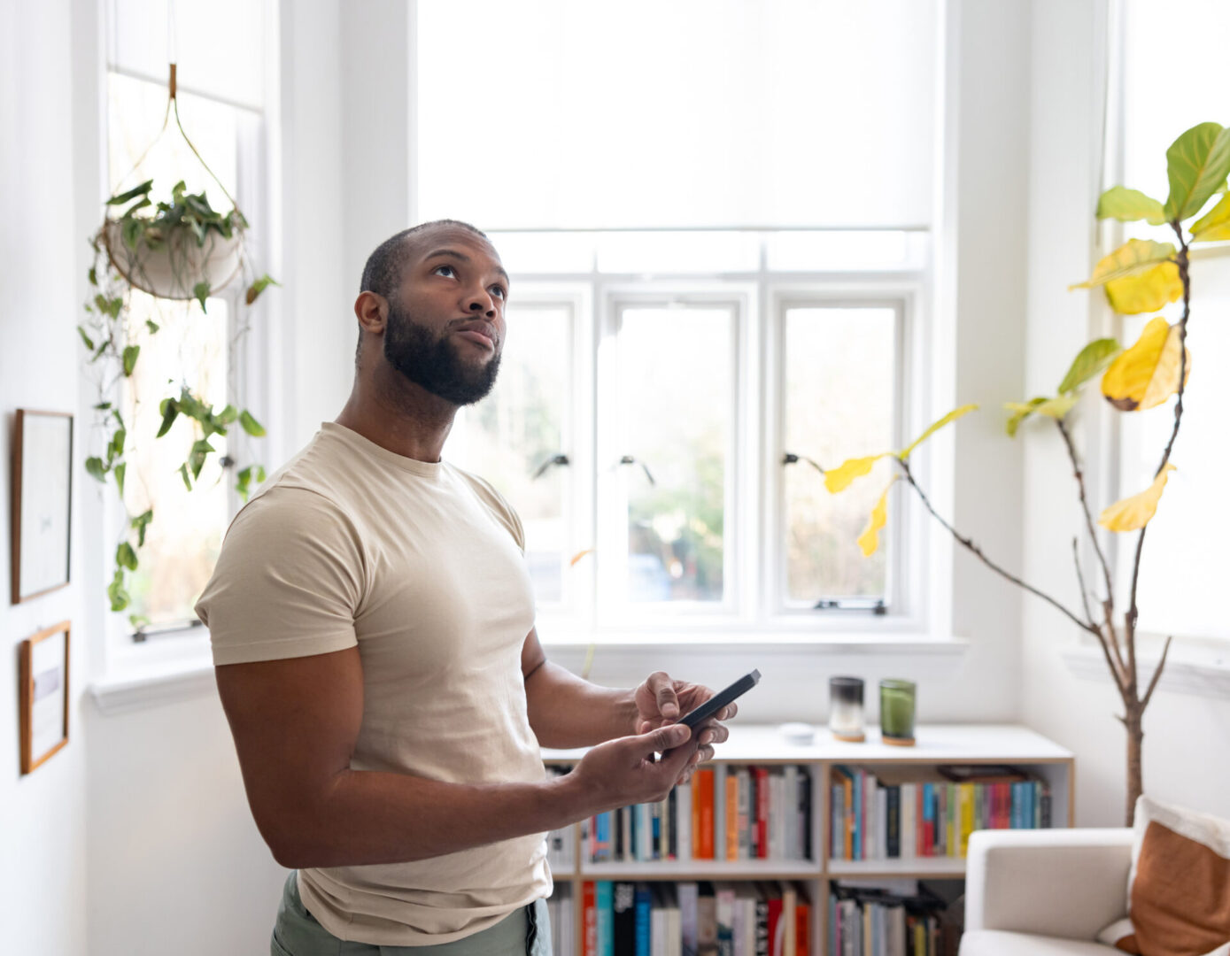 Person pondering in bright living room