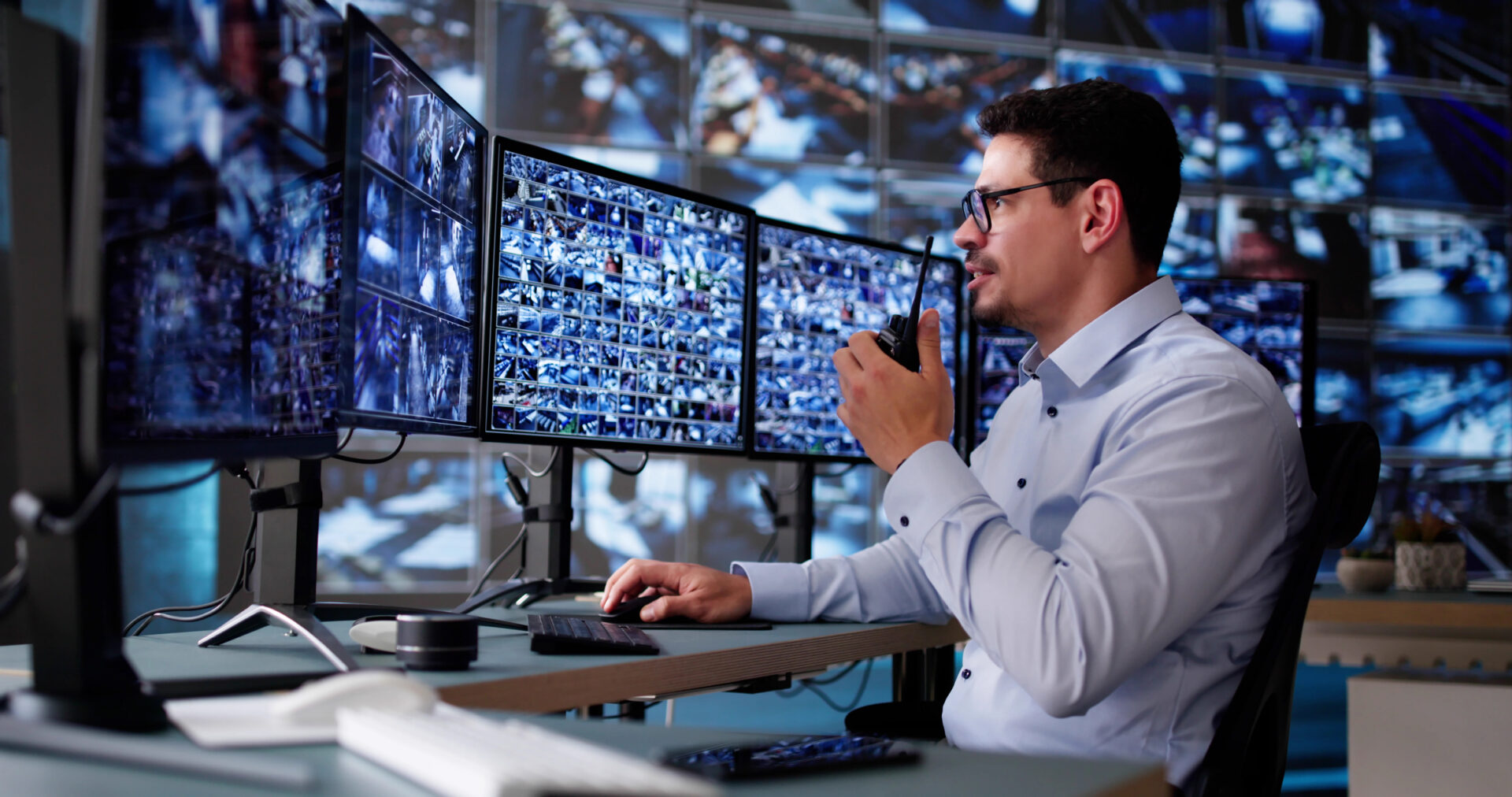Security officer using multiple computer monitors