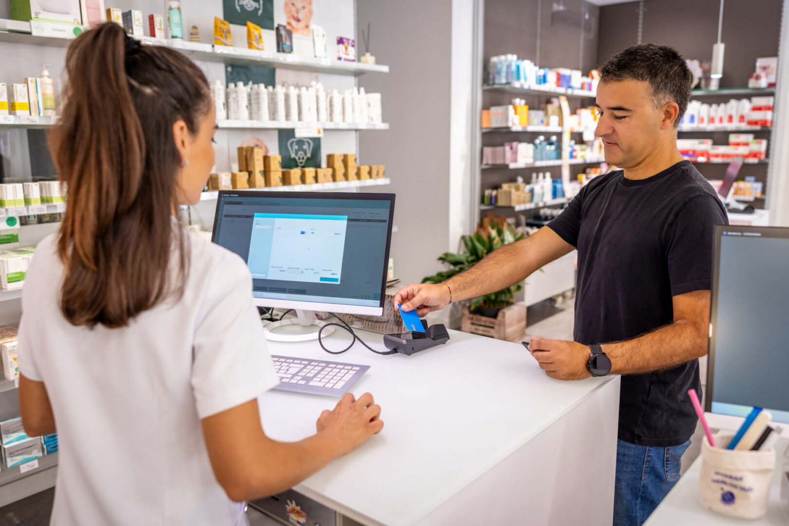 Woman assisting customer in pharmacy