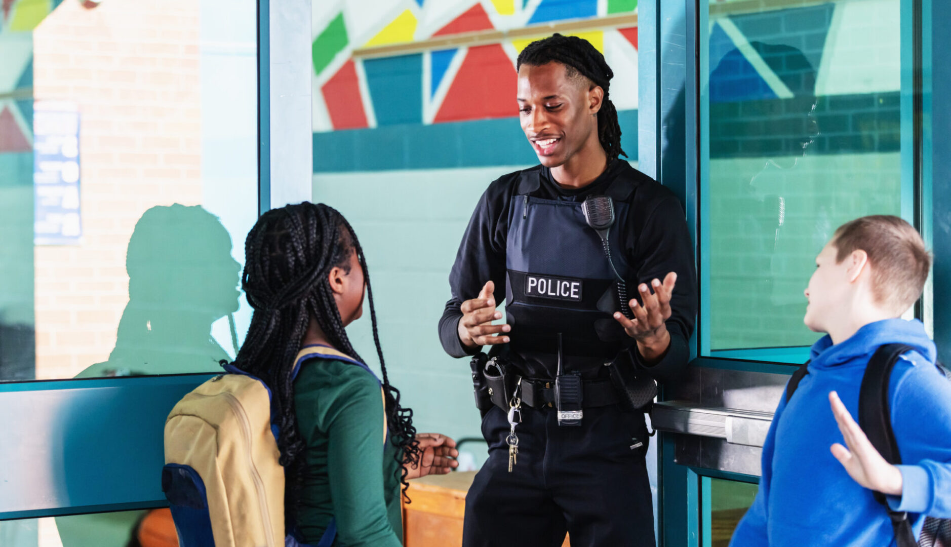 Police officer talking to school children