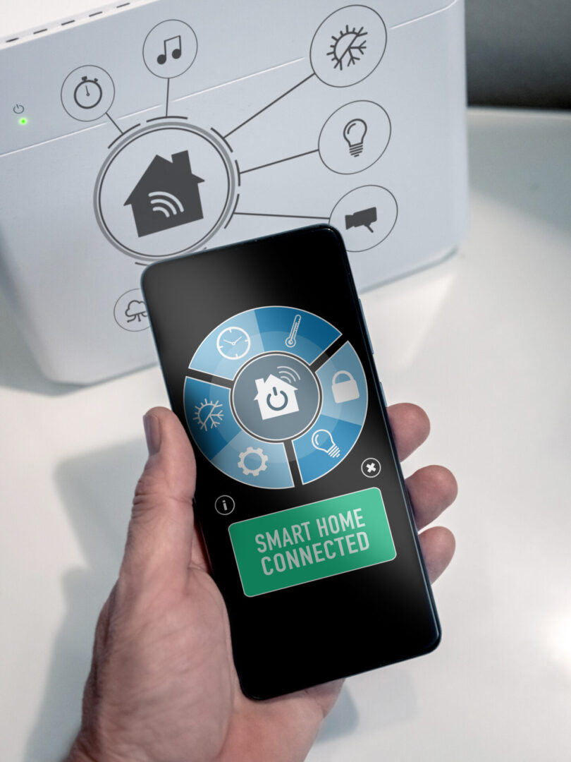 Hand holding smart home app screen