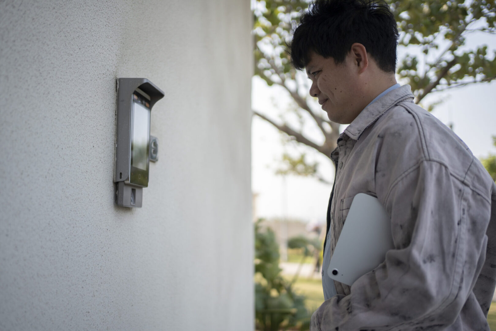 Person holding tablet near intercom