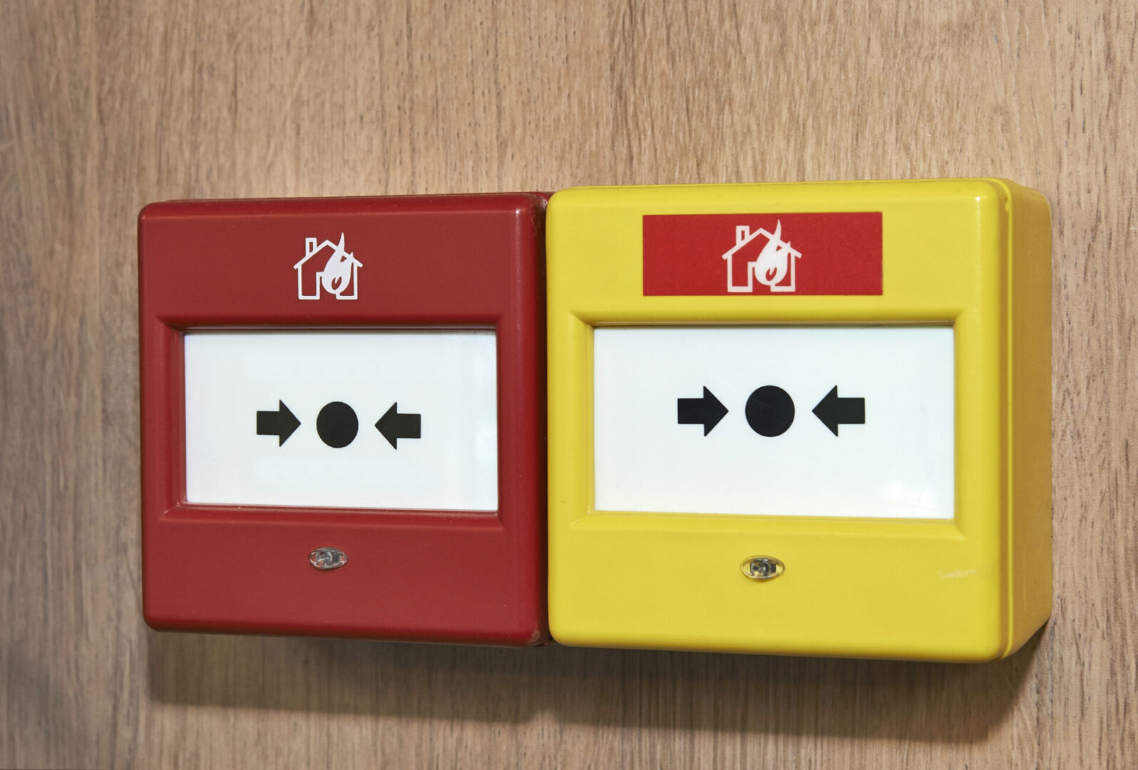 Fire alarm buttons on wooden wall
