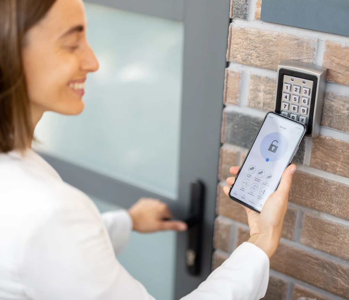 Smiling woman unlocking door digitally