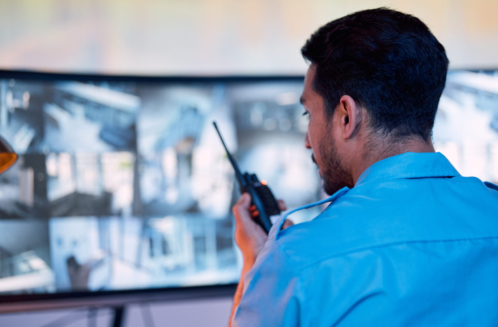 Man using walkie-talkie in control room