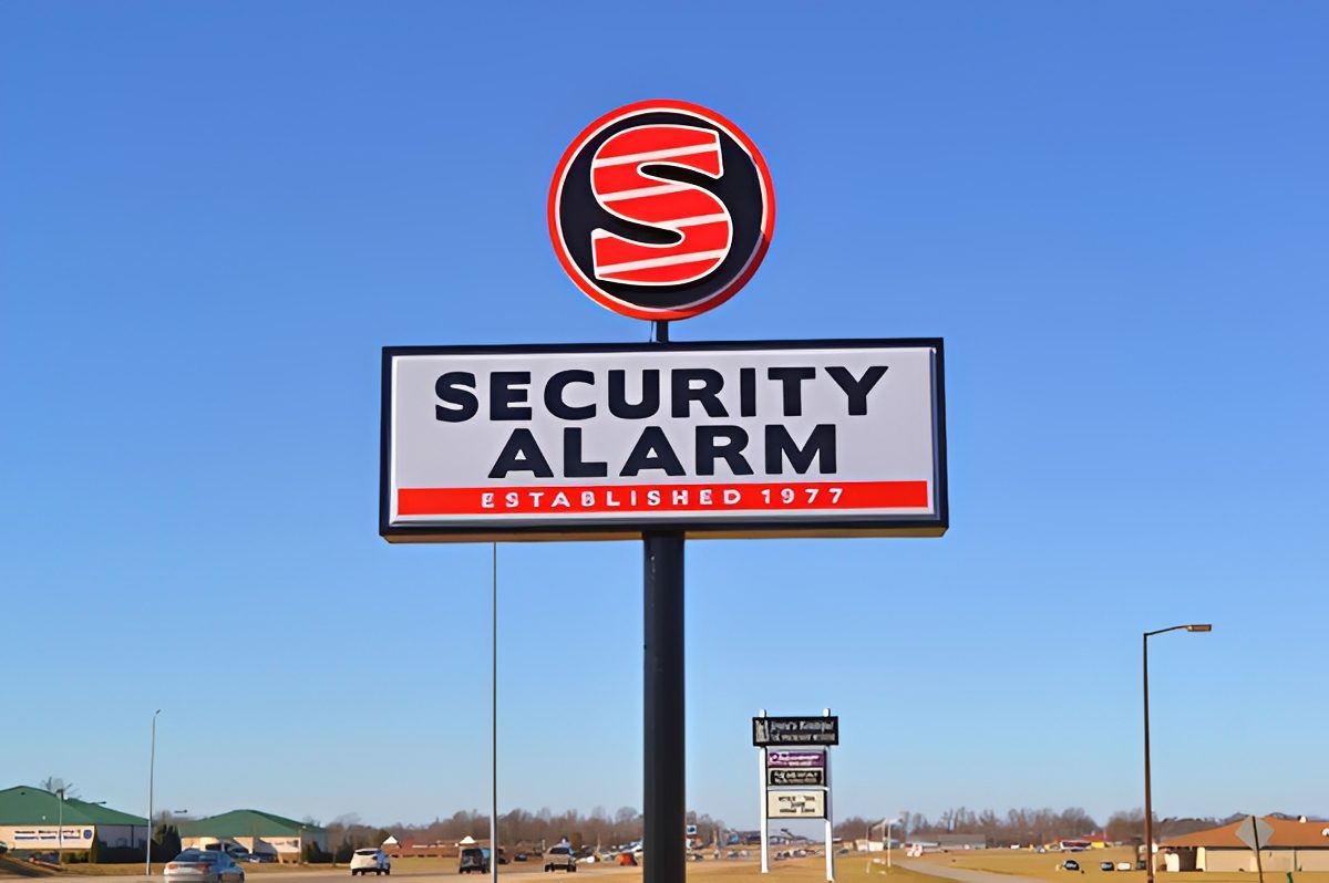 Security Alarm sign against clear blue sky