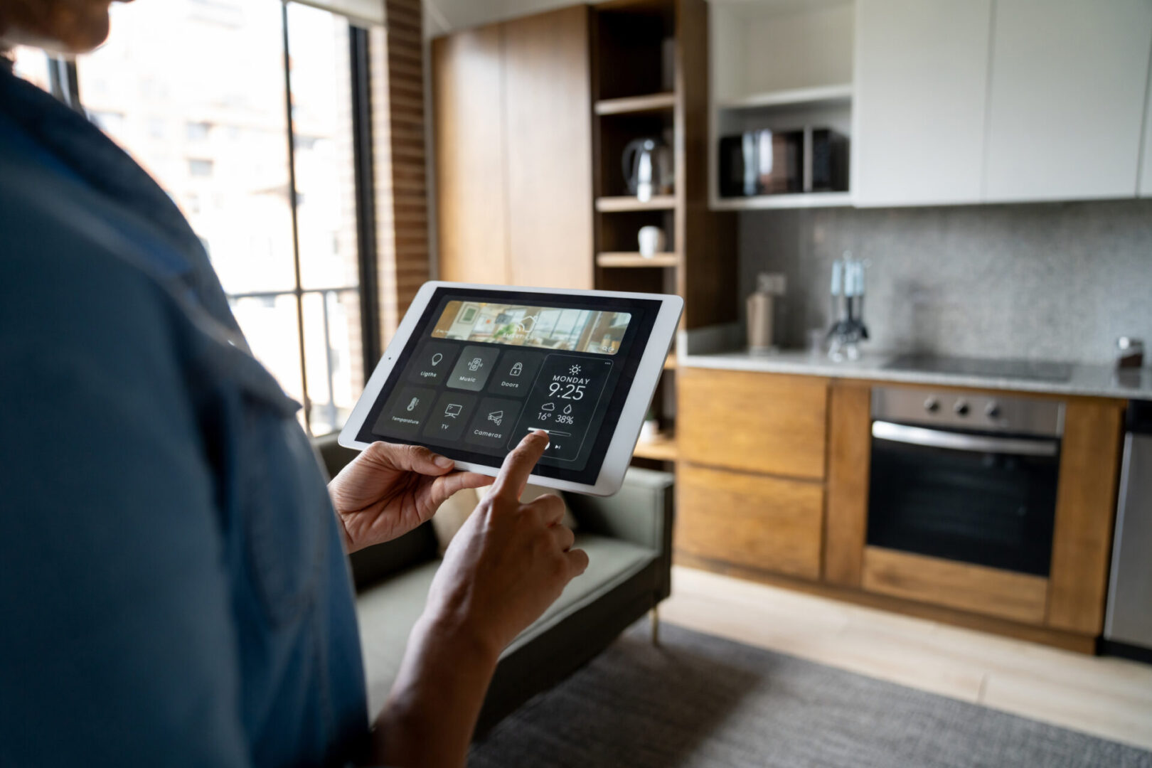 Person using a tablet in a modern kitchen.