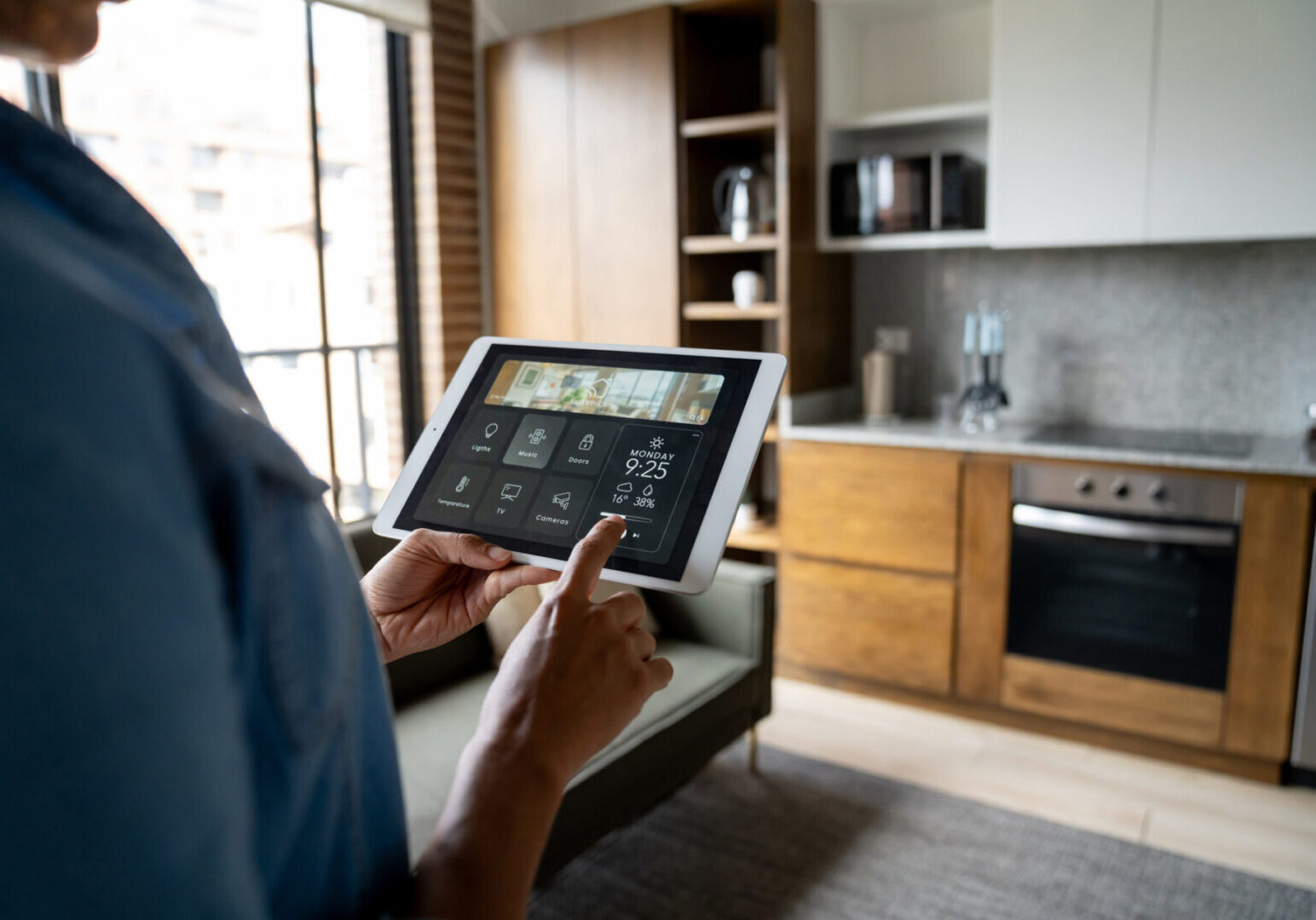 Person using a tablet in a modern kitchen.